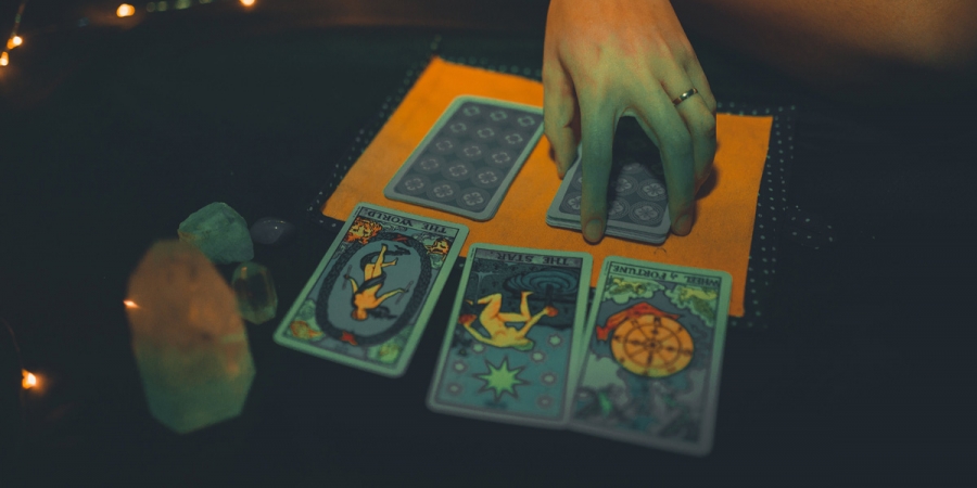 Female Fortune Teller With Tarot Cards On Table